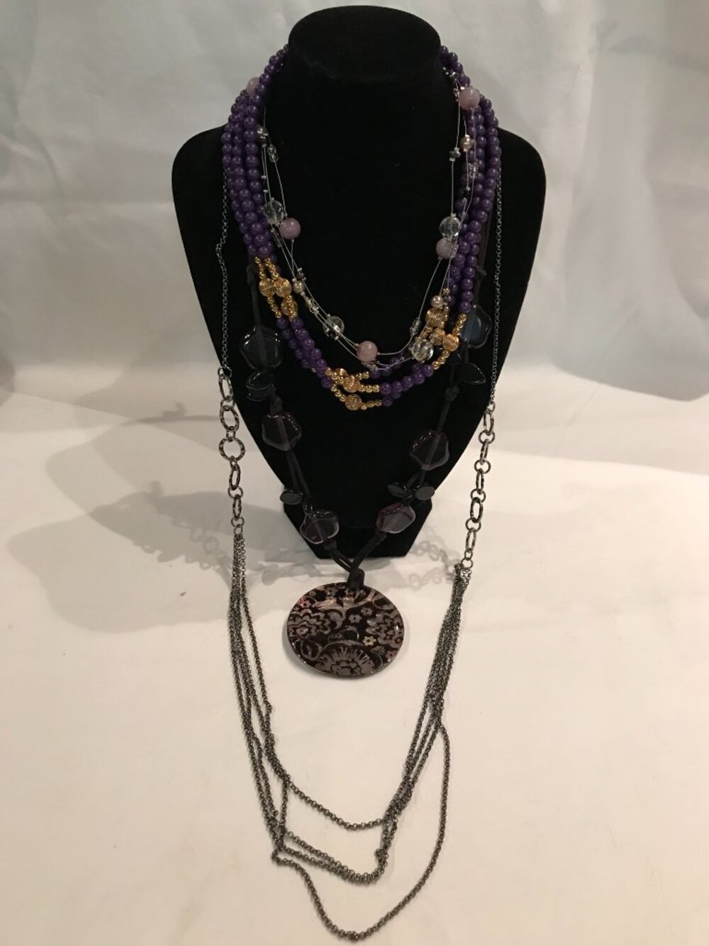 4 necklaces in purple tones